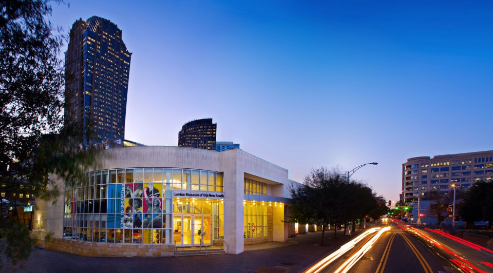 Image: The Levine Museum of the New South at sunset; car lights streaking