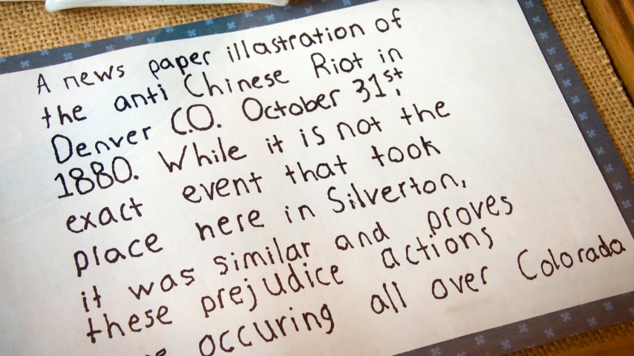 A handwritten label that reads, "A news paper illastration of the anti Chinese Riot in Denver C.O. October 31st, 1880. While it is not the exact event that took place here in Silverton, it was similar and proves these prejudice actions were occuring all over Colorado."