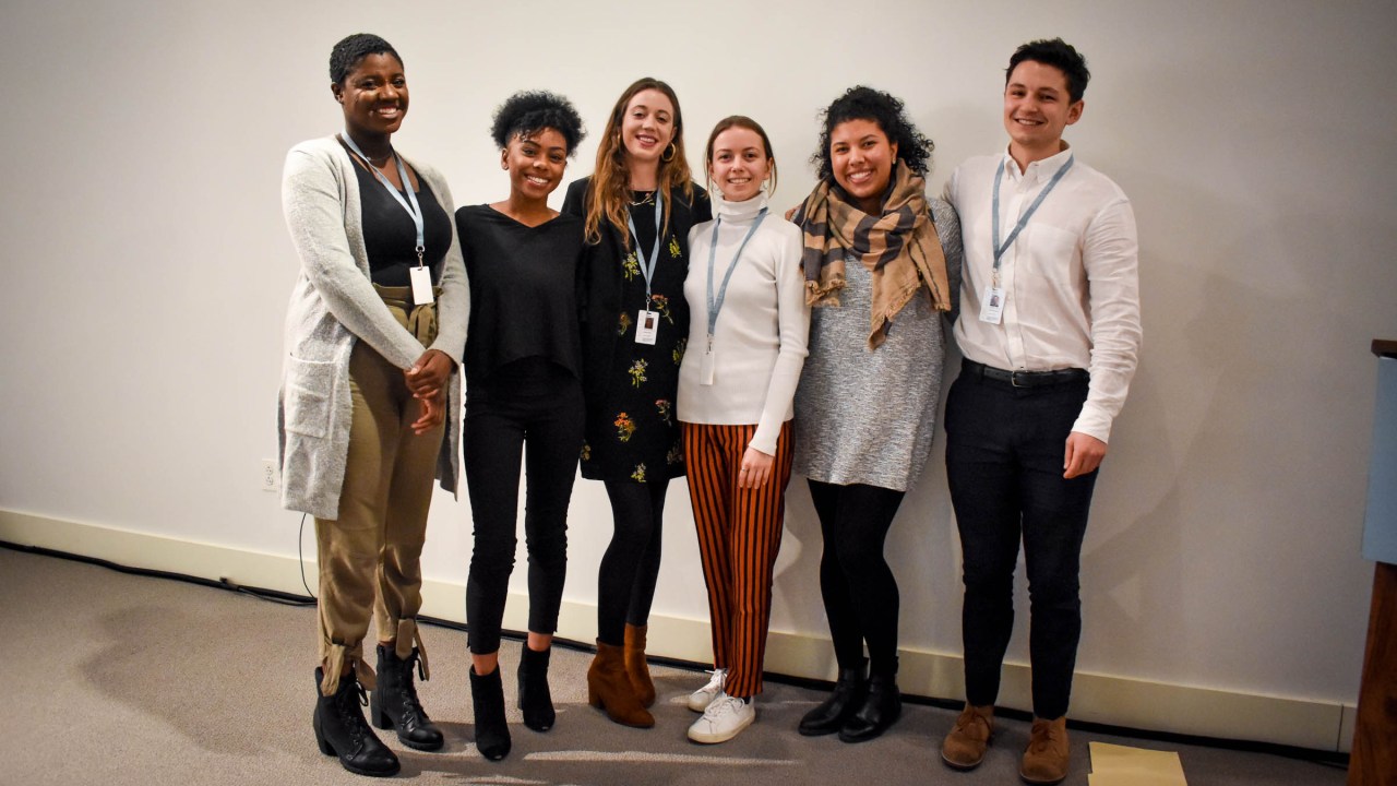 Six young, ethnically diverse interns who participated in the paid internship program pose for a group portrait.