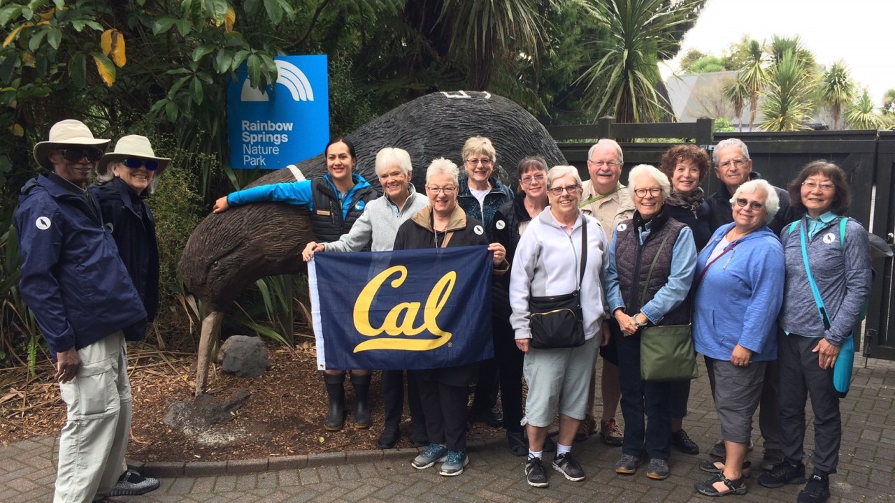 A group of older adults poses in front of a sign that reads "Rainbow Springs Nature Park"