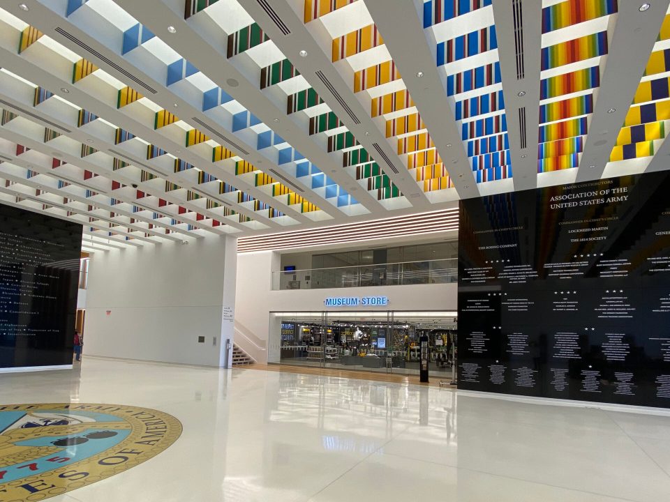 An airy museum lobby with the entrance to a museum store visible