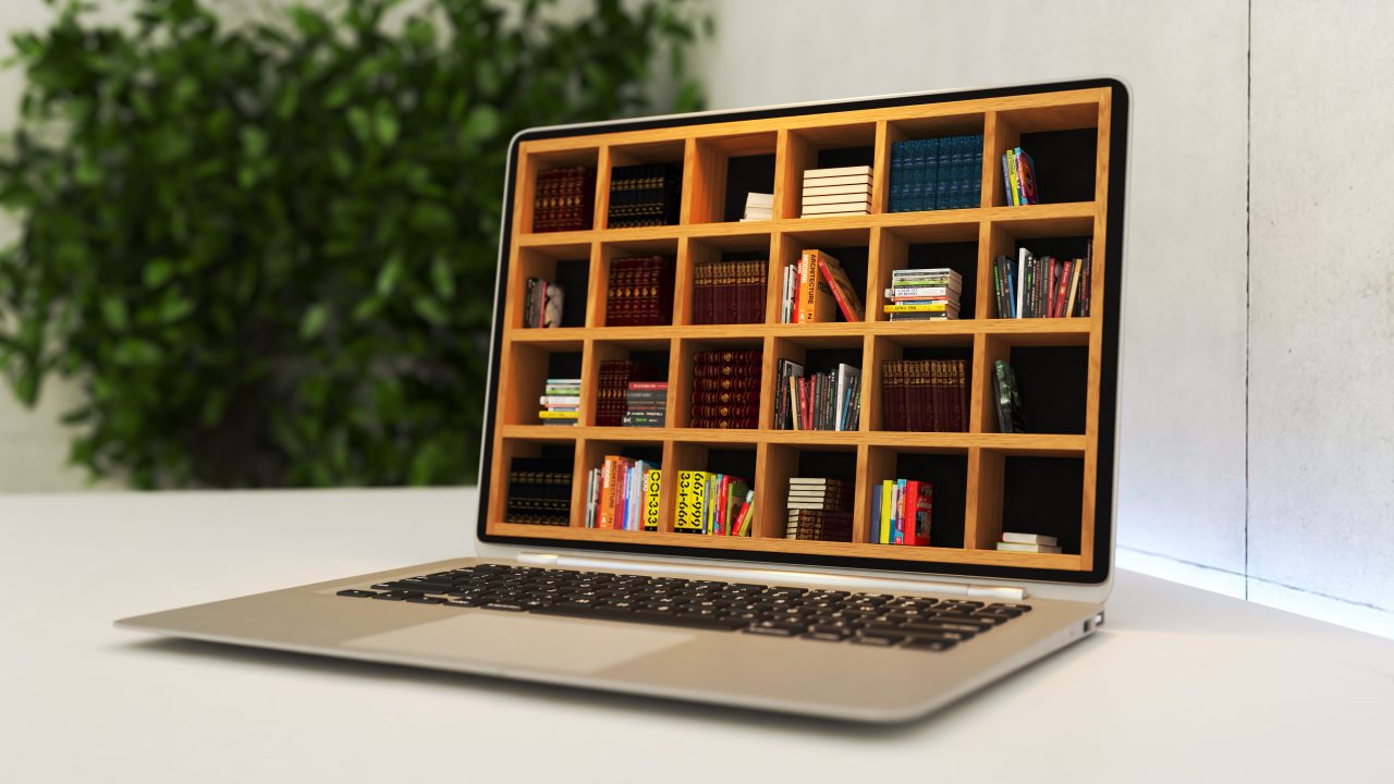 A laptop with the screen replaced with a shelving unit filled with books