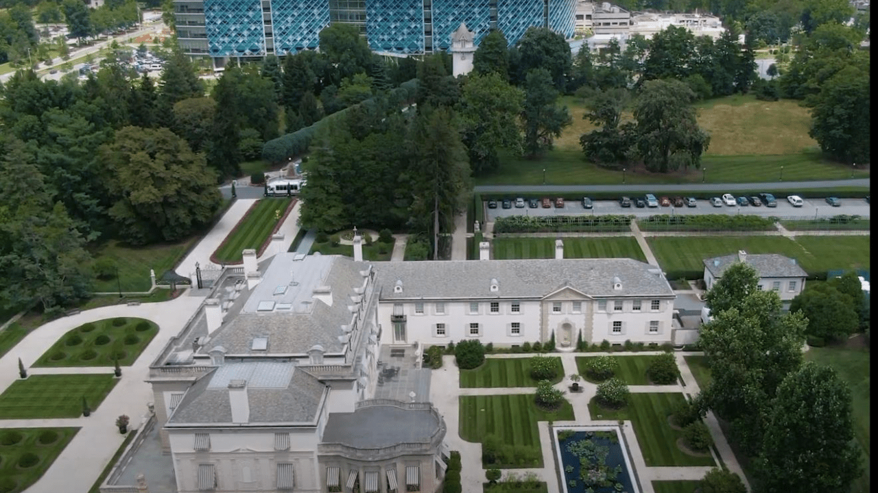 An aerial view of Nemours Estate Mansion, with a garden, and Nemours Children’s Hospital Delaware in the background.