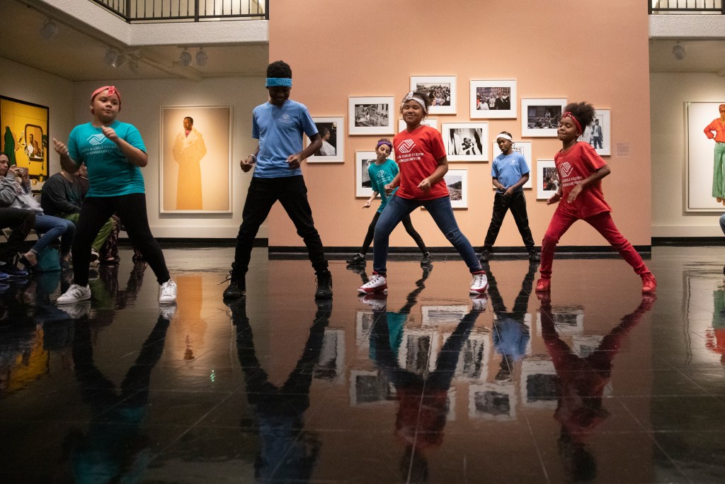 Children dancing in a museum gallery