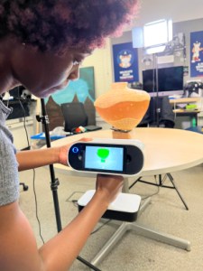 UA student Amelia Matherson doing 3D scanning of a basket pot by Terrol Dew Johnson, photograph by Lisa Falk, ASM.