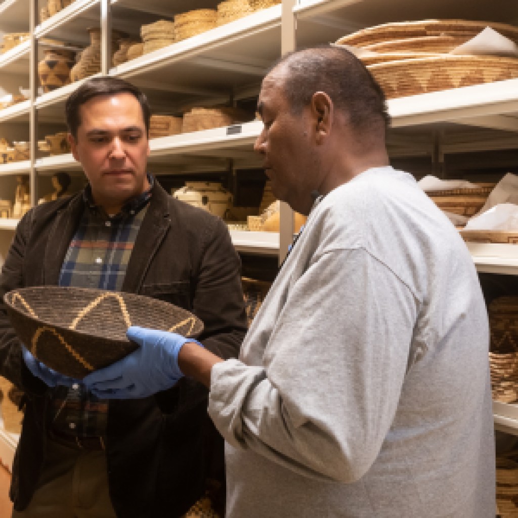 Terrol Dew Johnson, Tohono O’odham basketmaker, is recorded choosing objects with ASM associate curator Ed Jolie in Arizona State Museum’s vault, photograph by Max Mijn, ASM.