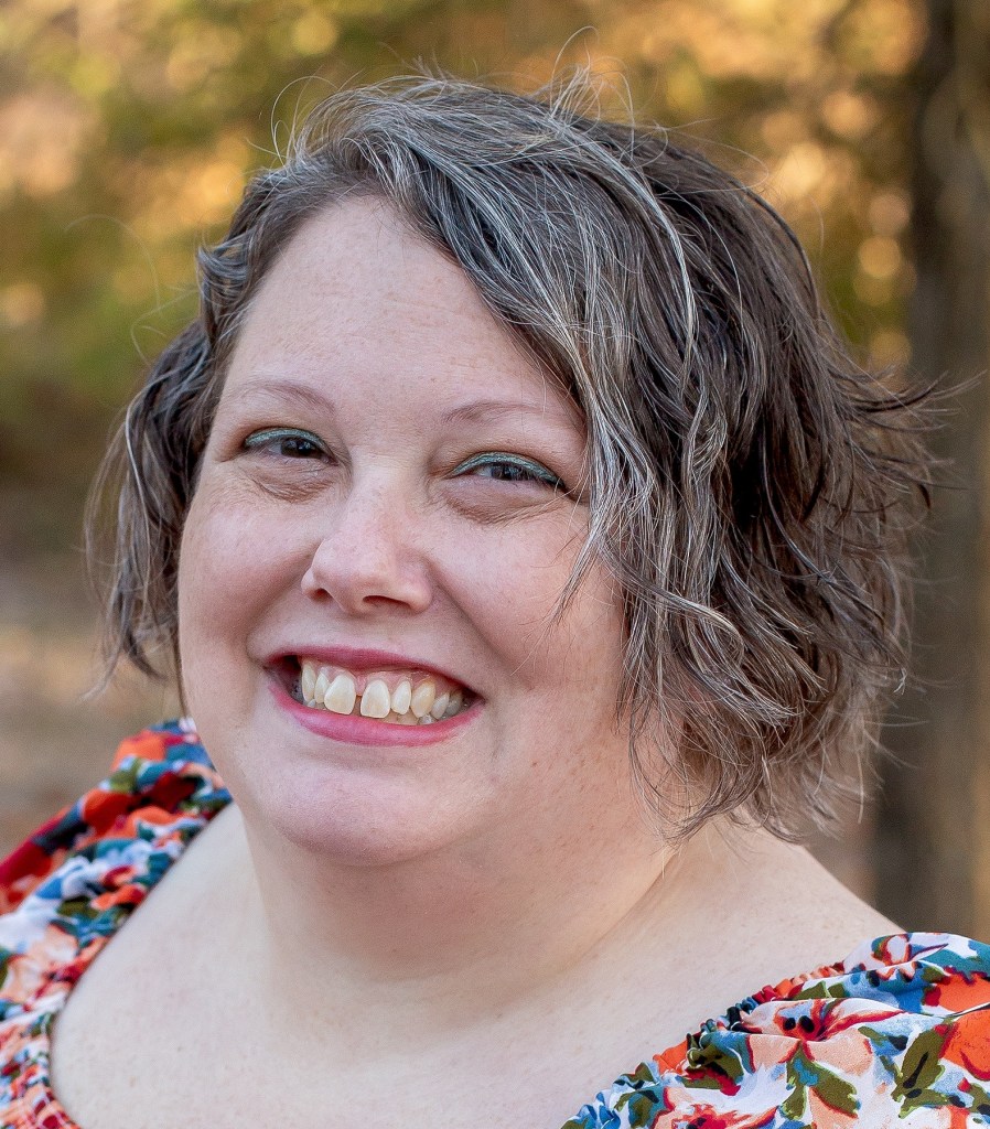 Woman with short greyish hair smiling