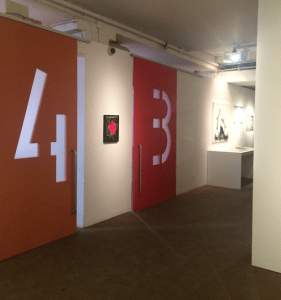 A gallery space with large 4 and 3 written on the walls.