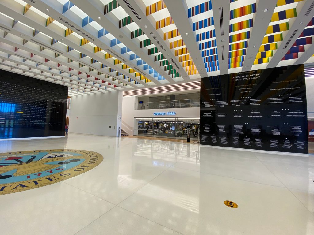 An airy museum lobby with a museum store entrance visible