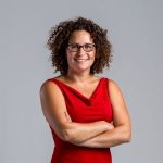 Image of Nina Simon in a red dress in front of a grey background